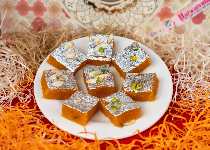 delicious traditional indian sweet topped with silver varq and garnished with almonds and pistachios